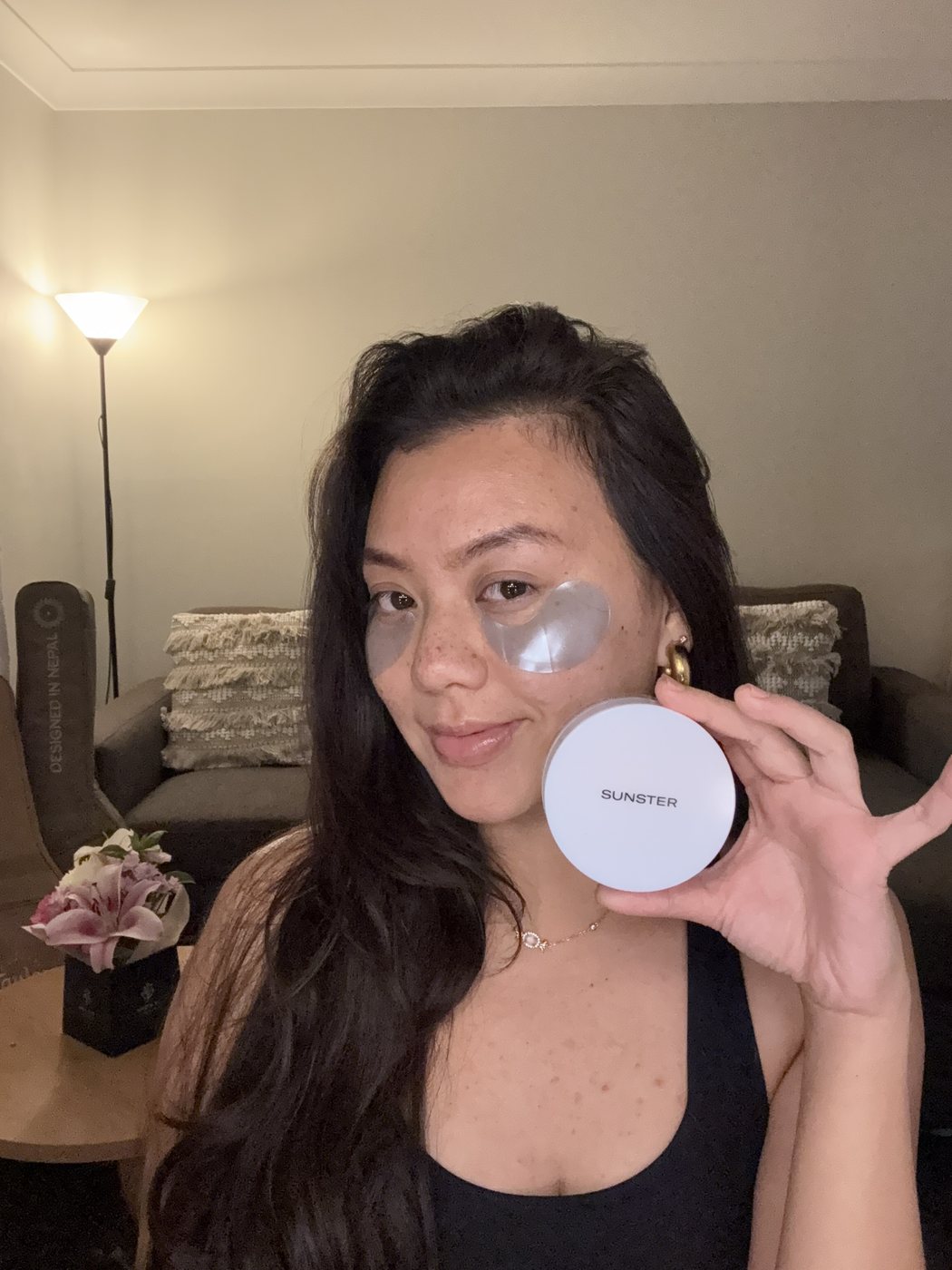 Ismriti wearing a silver under-eye patch and holding the tub