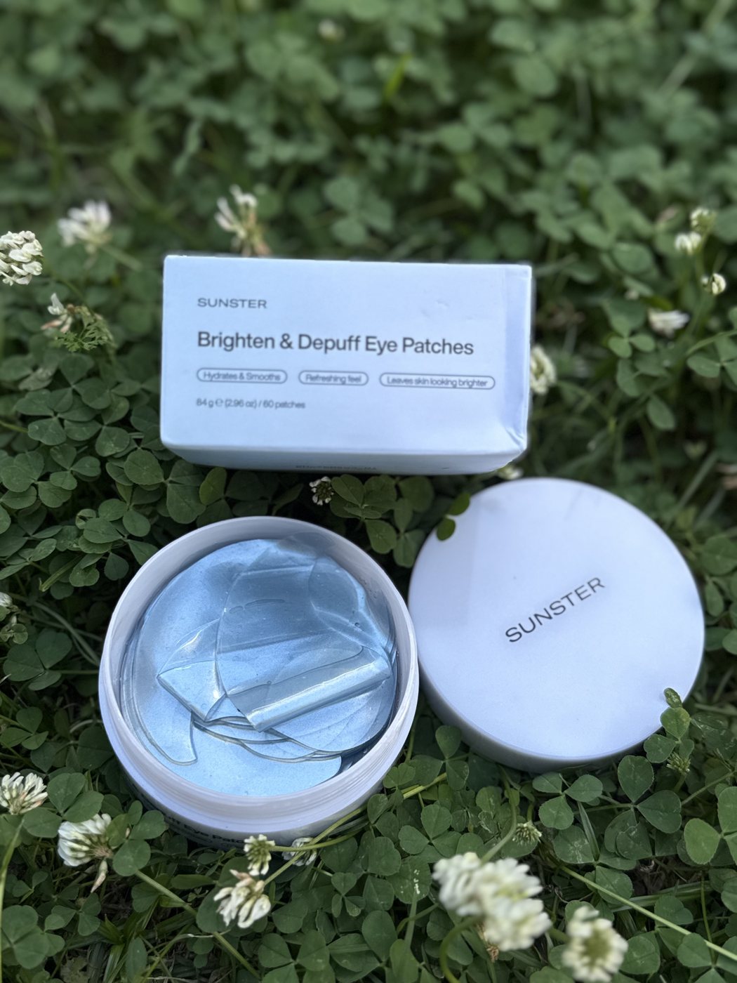 Eye patch tub and box resting on a patch of clover